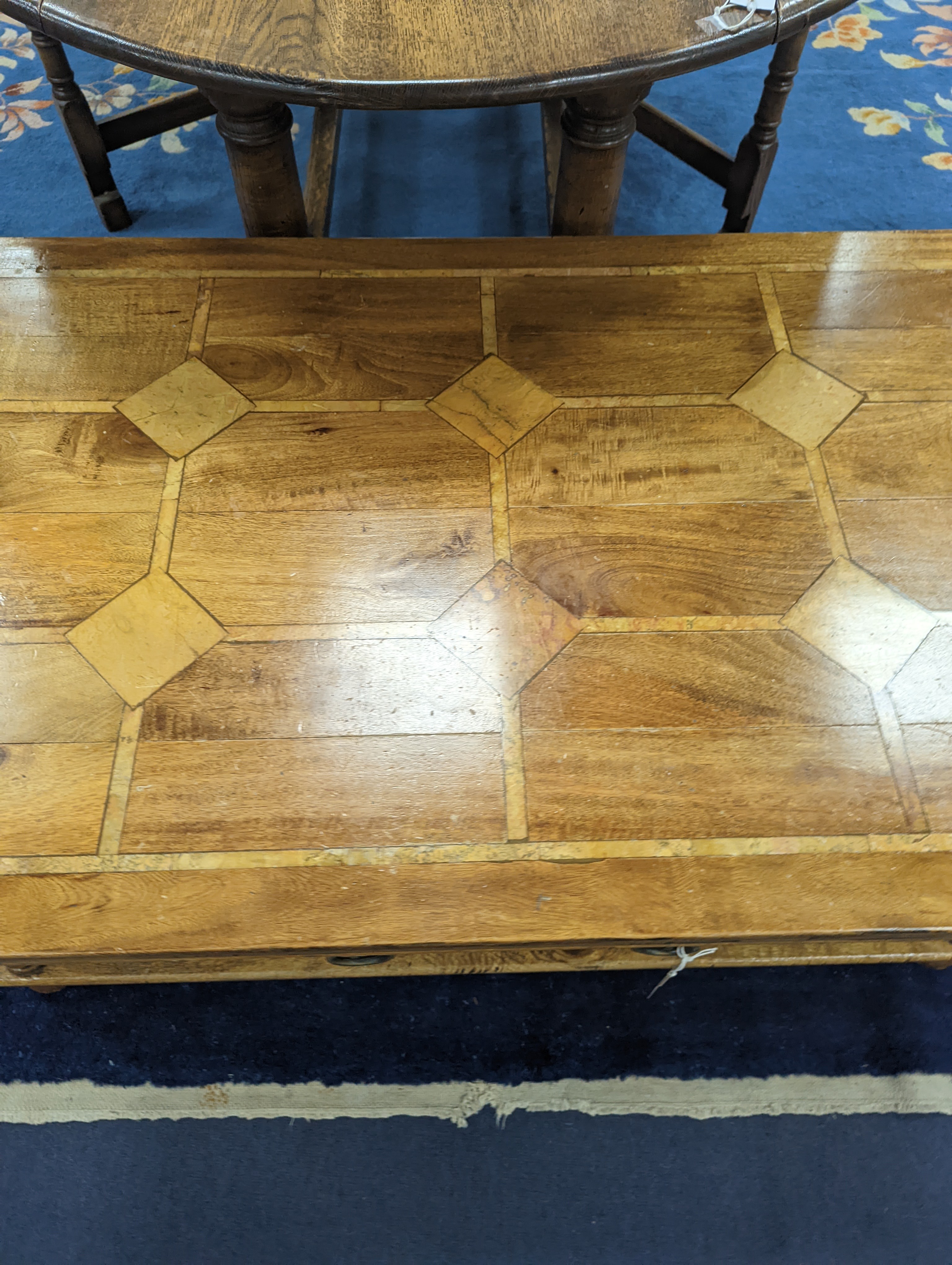 A hardwood and marble inset coffee table, length 130cm, depth 80cm, height 45cm